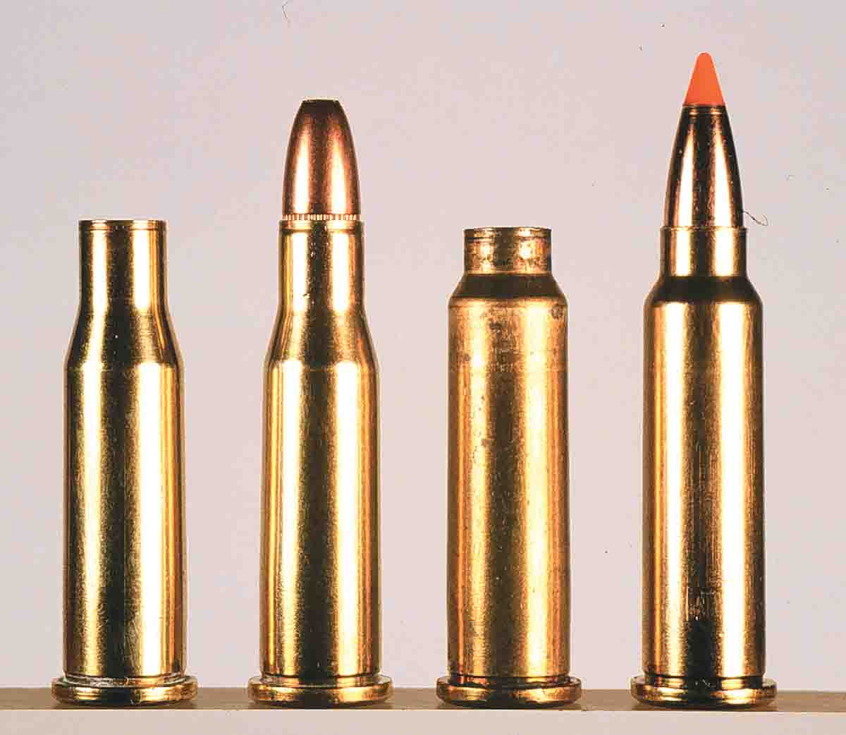 From left to right, the parent .218 Bee case is shown with a loaded .218 Bee factory round, a fireformed .218 Mashburn Bee and a loaded version.